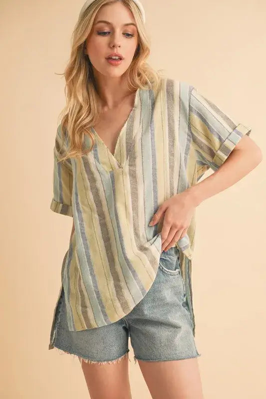 model is wearing a striped cotton short sleeve blouse by Aemi + Co