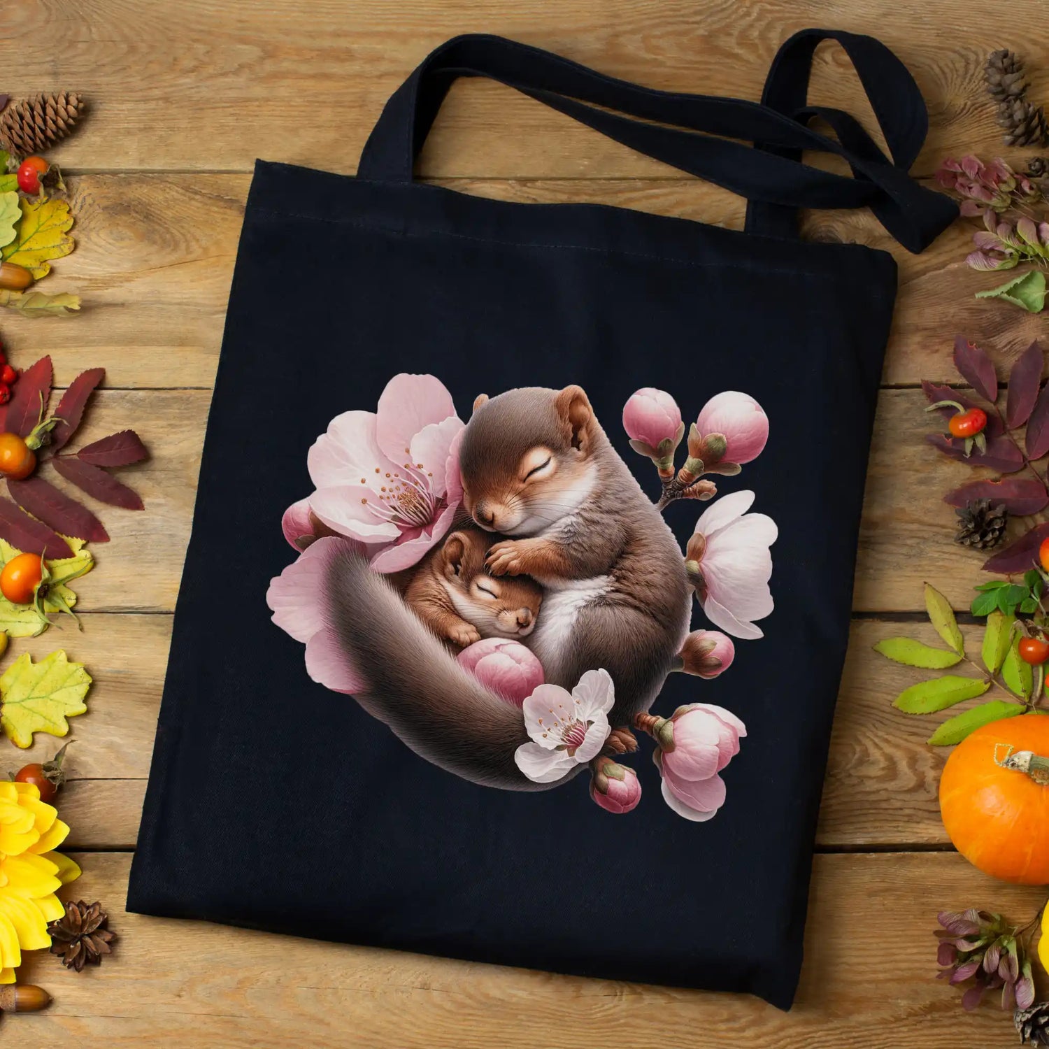 Black tote bag featuring sleeping mice surrounded by pink cherry blossoms.