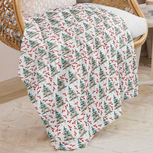 closer view of deer and trees blanket on a chair