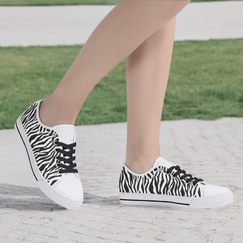 Zebra print canvas shoes white toe shown on sidewalk near grass