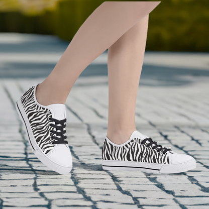 White toe zebra print canvas shoes shown on model posing on sidewalk with trees in background